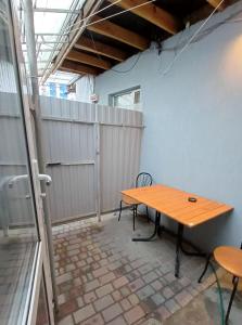 a wooden table sitting in the corner of a patio at 1 комн квартира, свой двор in Cherkasy