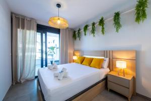 a bedroom with a large white bed with yellow pillows at Apartament Flamenca Village Lime & Lemon in Orihuela Costa +106 photos