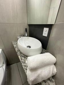 a bathroom with a sink and towels on a counter at Monyxbnb Hotel in Puerto Vallarta