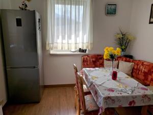 a kitchen with a table and a refrigerator at Bungalow Lindenweg in Bad Ischl