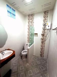 a bathroom with a toilet and a sink at Banpong Center Place in Ban Khung Phayom