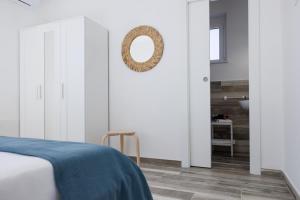 a bedroom with a bed and a mirror on the wall at Essentia Rooms & Relax in Vasto