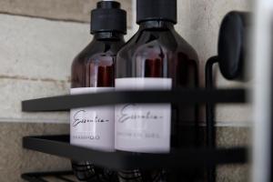 two bottles of wine sitting on a shelf at Essentia Rooms & Relax in Vasto