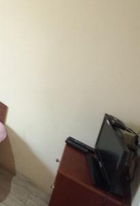 a tv sitting on top of a wooden dresser at 1 комн квартира, свой двор in Cherkasy +1 photo