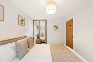 a bedroom with a large white bed in a room at Rock Mill 28 in Stony Middleton