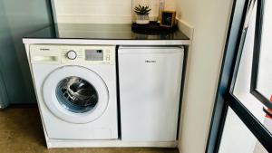 a washer and dryer with a counter on top of it at JHB City Living 119 - fibre Wi-Fi, washing machine & big sunny balcony in Johannesburg