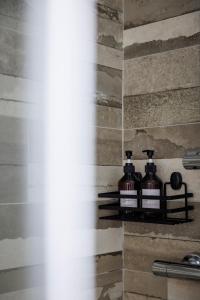 a bathroom with two bottles of soap on a shelf at Essentia Rooms & Relax in Vasto