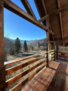 a view from the inside of a cabin with a wooden porch at Olko House in Yaremche