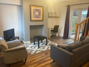 a living room with a couch and chairs and a table at Little Manor in Chesterfield