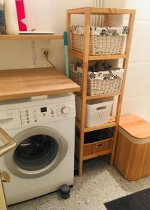 a laundry room with a washing machine and a shelf at Studio Saint Cyr sur mer,Vue mer in Saint-Cyr-sur-Mer