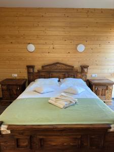 a bedroom with a bed with towels on it at Olko House in Yaremche