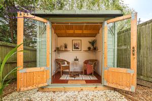 a wooden house with a table inside of it at 2 Bed 1 Bath House, Perfect for Corporate, Contractors & Families x2 FREE Parking, Garden, Netflix By REDWOOD STAYS in Alton