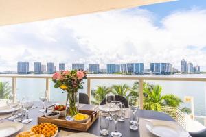 a table with wine glasses and a view of the ocean at Marina Bay 46 in Miami Beach