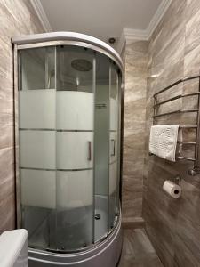 a glass shower in a bathroom with a toilet at Olko House in Yaremche