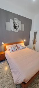 a bedroom with a large bed with a face on the wall at Family Dreams in Turin