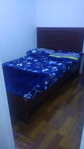 a bed with a blue comforter with stars on it at Ladies hostel near Burjuman Metro Station in Dubai