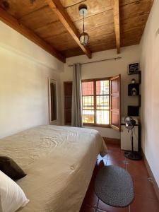 a bedroom with a bed and a window at Zoola Suites Antigua in Antigua Guatemala