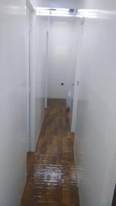 a hallway with white walls and a wooden floor at Ladies hostel near Burjuman Metro Station in Dubai