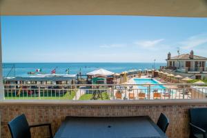 a view of the beach from the balcony of a resort at Residence Baiadosol in Lido di Fermo