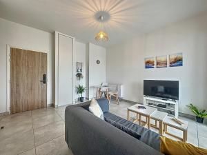 TV a/nebo společenská místnost v ubytování Le 121 - Appartement 101