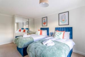a bedroom with two beds and a mirror at Trendy Sea View 2 bedroom Sleeps 6 - Free Parking in Bournemouth