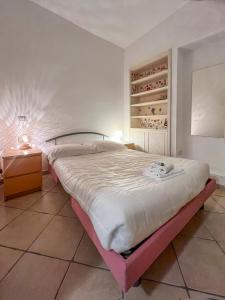 a bedroom with a large bed with a lamp on a table at Gianicolo - Spacious flat for family and friends in Rome