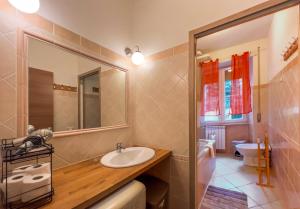 a bathroom with a sink and a mirror at Gianicolo - Spacious flat for family and friends in Rome