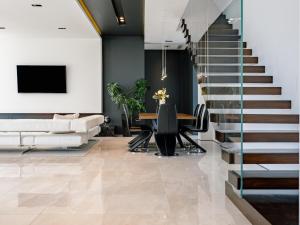 a living room with a staircase and a table with chairs at Calma Ii in Starigrad-Paklenica