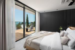 a bedroom with a large bed and a large window at Calma Ii in Starigrad-Paklenica +70 photos