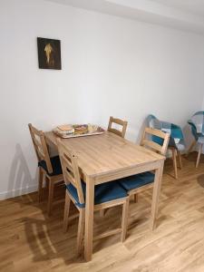 a wooden dining room table with four chairs at Charmante petite maison 2 personnes in Chambourg-sur-Indre