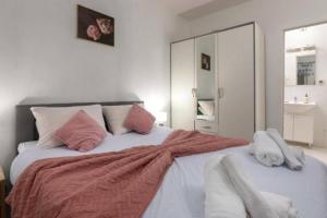 1 dormitorio con 1 cama grande con almohadas rosas en Casa Sara and Sasha near Motovun with private pool - Truffle Paradise en Oprtalj