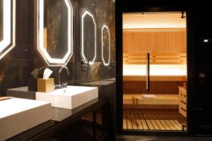 a bathroom with two white sinks and a tub at U-Visionary Roma Hotel in Rome