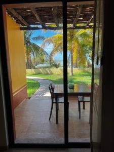 a door leading to a patio with a table and a view at Hotel Manglares in Celestún