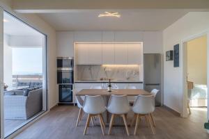 a kitchen with a table and chairs in a room at Diamond Nevelo Quality Villas in Gerani