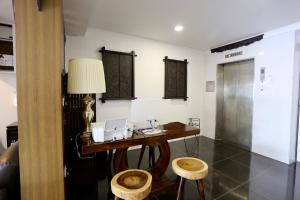 a room with a desk with a laptop on it at Fata Hotel by Project Borneo in Kuching