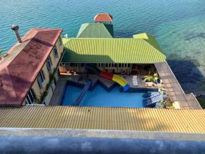 an aerial view of a house with a slide at Ribiera del Lago Peten Itza in Flores