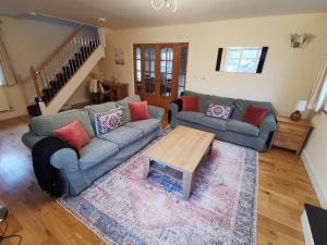 a living room with a couch and a coffee table at Unbeatable Llanberis Location, Detached with Parking, Snowdon Views. in Llanberis