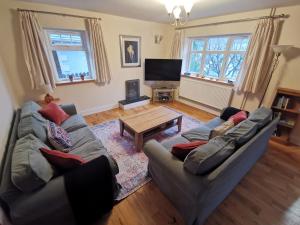 a living room with two couches and a coffee table at Unbeatable Llanberis Location, Detached with Parking, Snowdon Views. in Llanberis