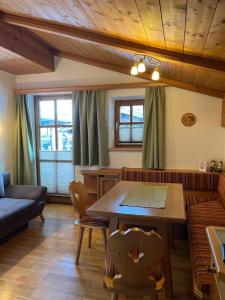 a living room with a table and a couch at Wirtshäusl Maria Alm in Maria Alm am Steinernen Meer