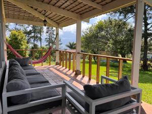 a porch with a hammock and a gazebo at La Dama de los vientos in Cerro Azul