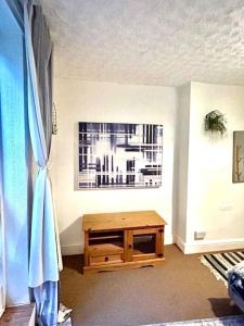 a room with a wooden table and a window at Seafront Balcony Apartment in Hastings