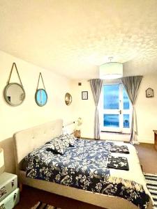 A bed or beds in a room at Seafront Balcony Apartment