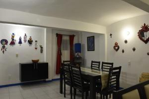 a dining room with a table and chairs at Casa Gris Alemán in Oaxaca City