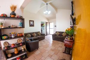 a living room with two couches at Casa Gris Tule in Santa María del Tule