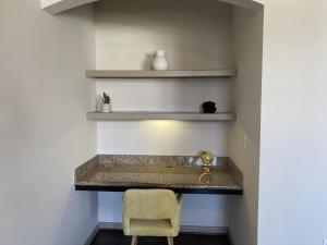 a room with a counter with a chair and shelves at Luxe Getaway Astros NRG Galleria in Houston