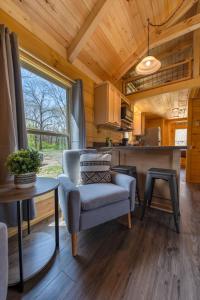 a living room with a chair and a kitchen at Jake Cabin Luxury Hot Tub Cabin Near Downtown in Chattanooga