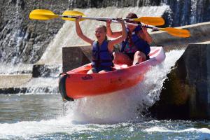 a couple of people in a kayak in the water at Camping la Rouvière in Chame