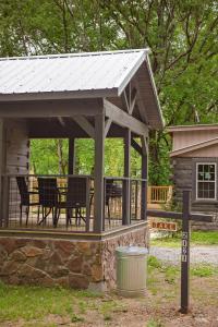 a pavilion with a table and chairs on a deck at Jake Cabin Luxury Hot Tub Cabin Near Downtown in Chattanooga