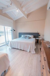 1 dormitorio con cama blanca y ventana grande en La Santina Posada & Experiencias de Campo en San Pedro