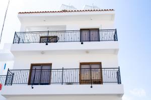 a white building with balconies on it at Modern 2bd appartment near mall- Internet 1Gbps in Paphos
